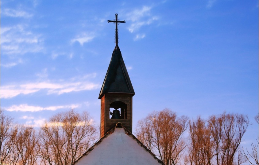 Exterior view of a church tower, symbolizing a faith-based organization that could operate as a private ministerial association