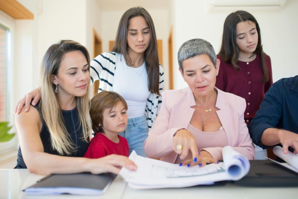 A family seated at a table reviewing trust documents with a financial advisor.