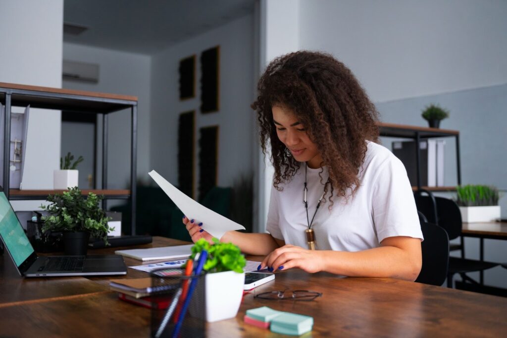 Person reviewing and comparing legal documents at a desk.