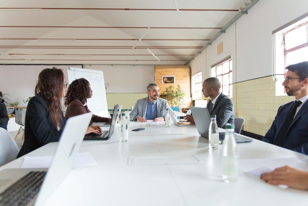 A nonprofit board of directors reviewing governance and compliance documents during a private foundation operations meeting.