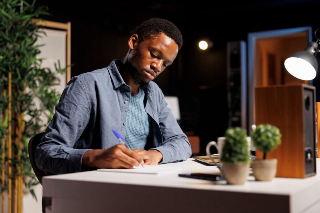 A person reviewing and signing legal trust documents at a desk
