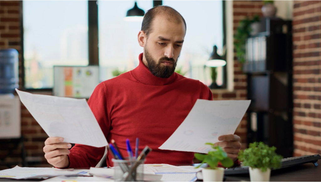 Business owner reviewing asset protection documents at a desk