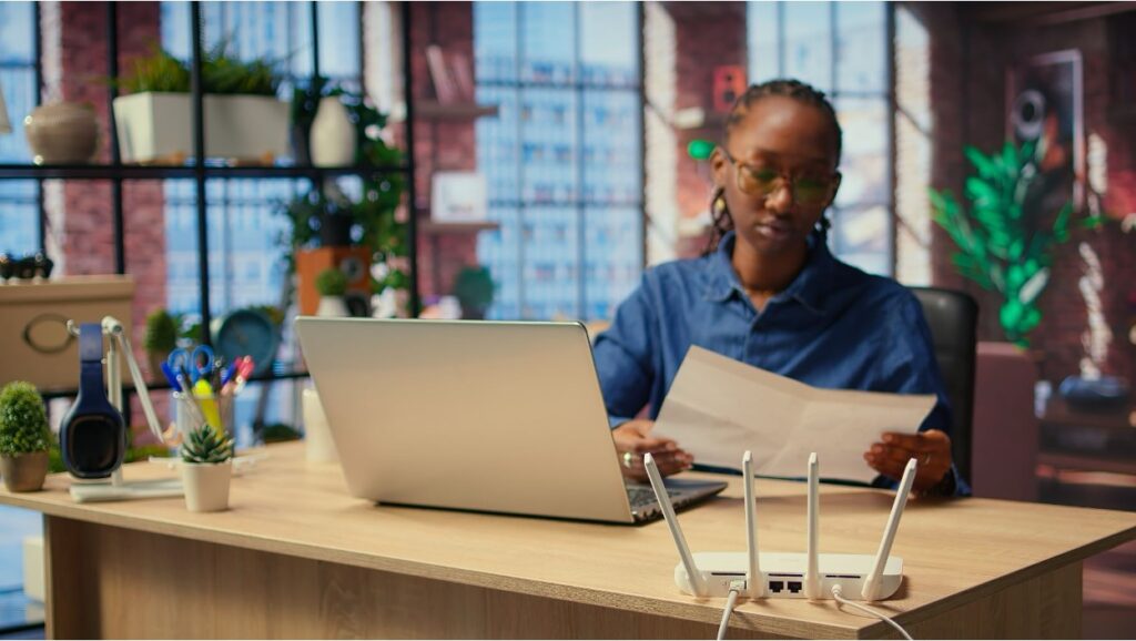 Business owner reviewing documents on entity structures for asset protection at an office desk