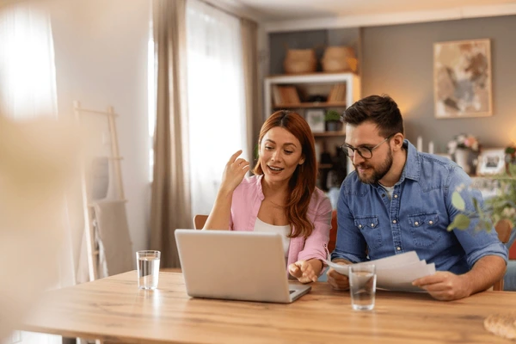 Couple at home reviewing legal paperwork and researching Private Membership Association case law together on a laptop.