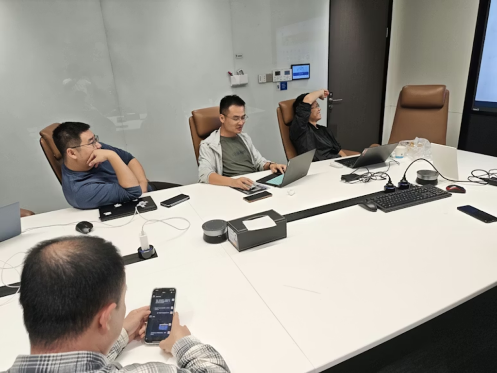 Diverse professionals around a boardroom table as one member addresses the group, illustrating a private membership association in action.
