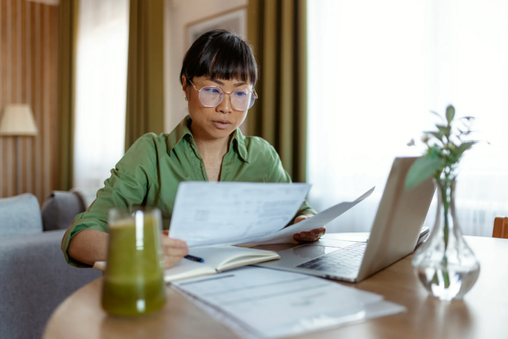 Nonprofit administrator comparing 501(c)(3) and 501(c)(9) tax-exemption requirements on a laptop at her desk