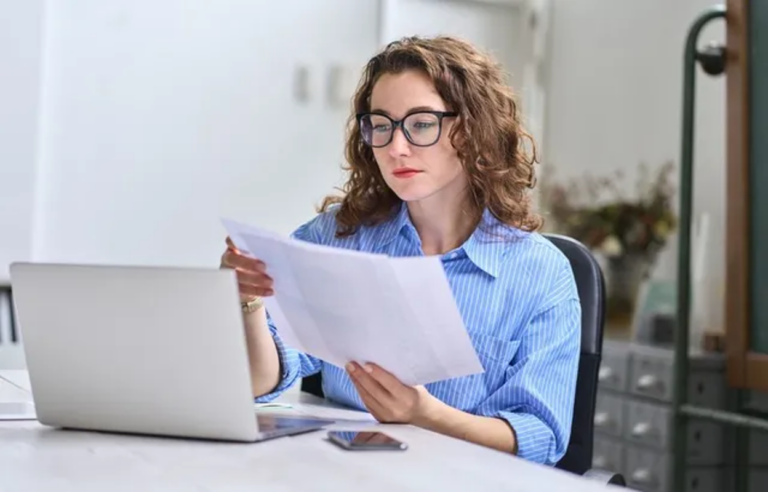 Nonprofit administrator comparing 501(c)(3) and 501(c)(12) IRS forms at her desk to select the right tax-exempt status.