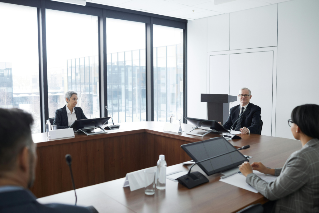 Business professionals comparing LLC alternatives and entity structures around a boardroom table.
