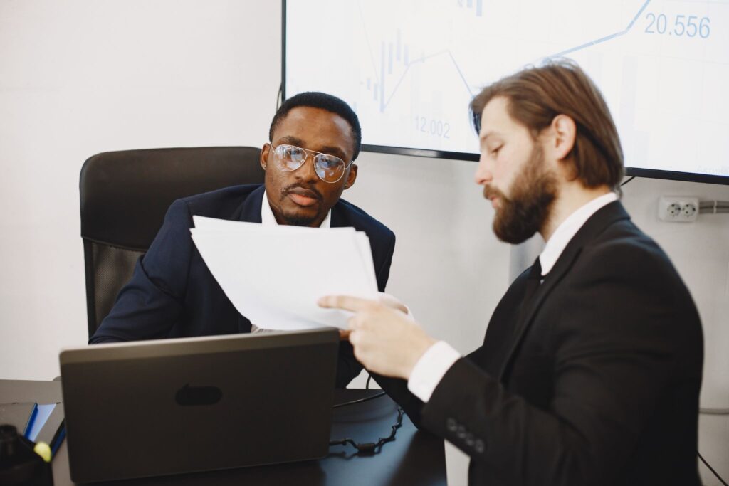 Attorney and client reviewing trust and corporation documents for long-term asset protection planning.