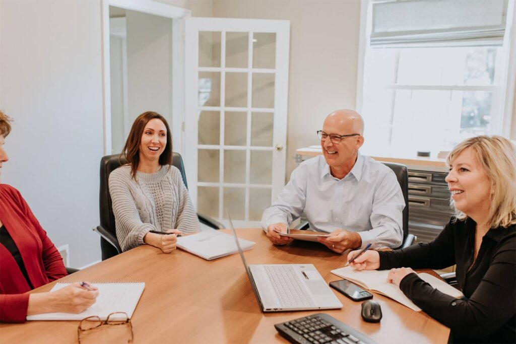 Family members reviewing governance documents around a conference table to plan their business structure.