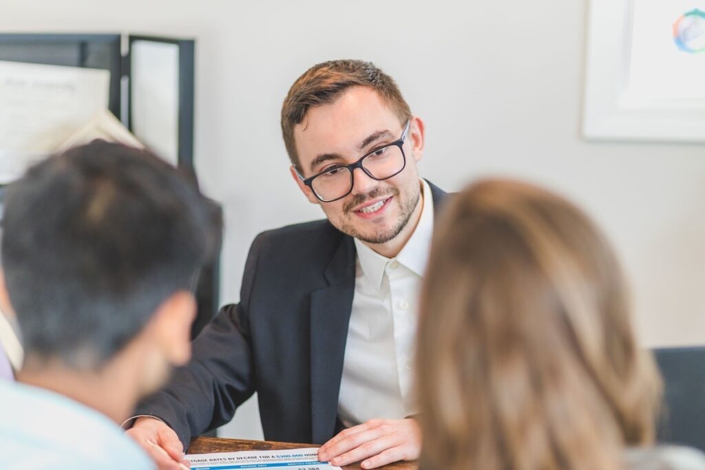 Estate planning advisor reviewing trust documents with a couple during a consultation meeting