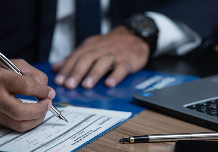 A person signing a legal birth certificate.