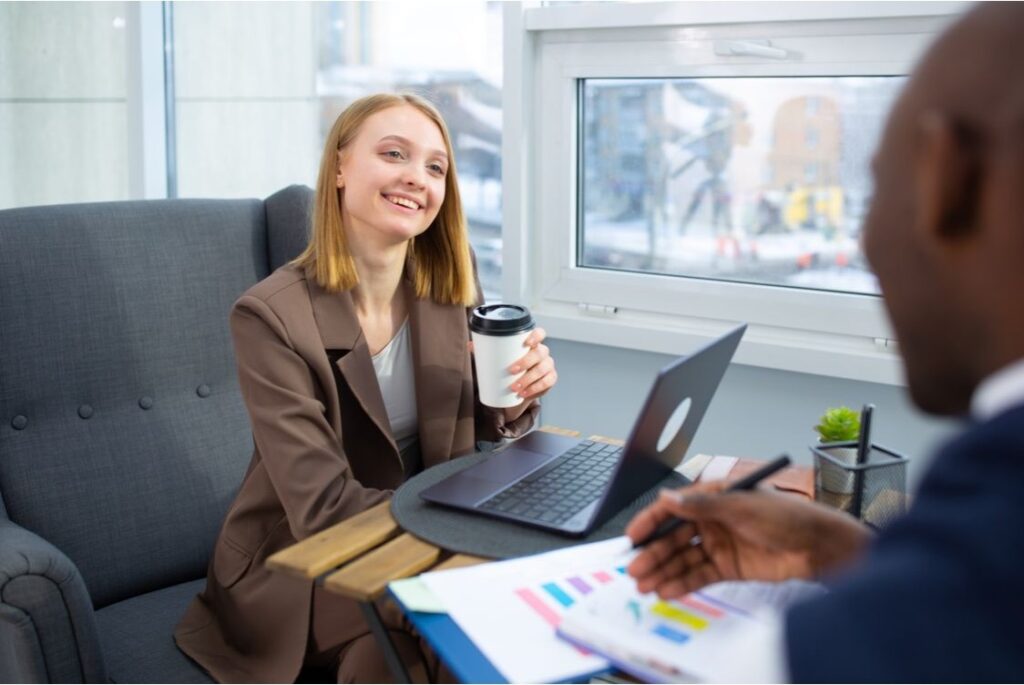A client and an advisor discussing financial documents during a casual planning meeting.Â