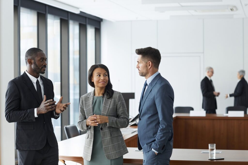 Business professionals discussing PMA governance in a private setting.